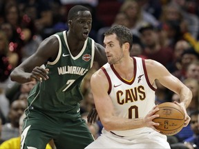 Cleveland Cavaliers' Kevin Love (0) drives against Milwaukee Bucks' Thon Maker (7), from Australia, in the second half of an NBA basketball game, Tuesday, Nov. 7, 2017, in Cleveland. The Cavaliers won 124-119. (AP Photo/Tony Dejak)