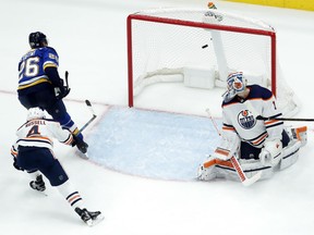 Paul Stastny of the Blues scores past Edmonton Oilers goalie Laurent Brossoit and Kris Russell during the third period of their game Tuesday night in St. Louis. The Blues won 8-3.