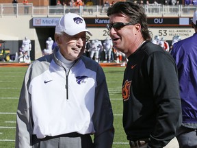 Oklahoma State head coach Mike Gundy, right, talks with Kansas State head coach Bill Snyder, left, before their an NCAA college football game in Stillwater, Okla., Saturday, Nov. 18, 2017. (AP Photo/Sue Ogrocki)