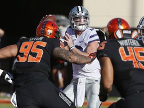 Kansas State quarterback Skylar Thompson (10) passes under pressure from Oklahoma State defensive end Vili Leveni (95) and linebacker Chad Whitener (45) in the first half of an NCAA college football game in Stillwater, Okla., Saturday, Nov. 18, 2017. (AP Photo/Sue Ogrocki)
