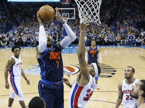 Oklahoma City Thunder forward Carmelo Anthony, left, shoots in front of Detroit Pistons forward Tobias Harris, right, in the first quarter of an NBA basketball game in Oklahoma City, Friday, Nov. 24, 2017. (AP Photo/Sue Ogrocki)