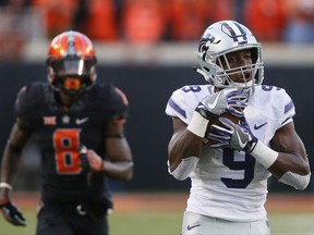 Kansas State wide receiver Byron Pringle (9) catches a pass in front of Oklahoma State cornerback Rodarius Williams (8) and carries it in for a touchdown in the second half of an NCAA college football game in Stillwater, Okla., Saturday, Nov. 18, 2017. Kansas State won 45-40. (AP Photo/Sue Ogrocki)