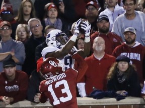 TCU wide receiver John Diarse (9) reaches for the ball but can't hold on as Oklahoma cornerback Tre Norwood (13) breaks up the play in the second half of an NCAA college football game in Norman, Okla., Saturday, Nov. 11, 2017. Oklahoma won 38-20. (AP Photo/Sue Ogrocki)