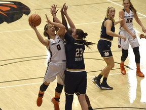 Oregon State's Mikayla Pivec (0) shoots around Notre Dame's Jessica Shephard (23) and Jackie Young during an NCAA college basketball game Sunday, Nov. 19, 2017, in Corvallis, Ore (Mark Ylen/Albany Democrat-Herald via AP)