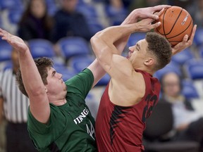 Stanford forward Reid Travis, right, has his shot blocked by Portland State center Ryan Edwards during the first half of an NCAA college basketball game in the Phil Knight Invitational tournament in Portland, Ore., Sunday, Nov. 26, 2017. (AP Photo/Craig Mitchelldyer)