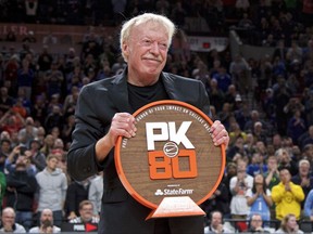 Nike co-founder Phil Knight is presented with a plaque during the first half of an NCAA college basketball game between Duke and Florida in the Phil Knight Invitational tournament in Portland, Ore., Sunday, Nov. 26, 2017. (AP Photo/Craig Mitchelldyer)