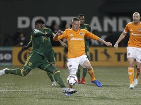 Houston Dynamo's Dairon Asprilla, left, scores a goal during the second leg of their 2017 MLS Cup soccer playoffs matchup of the Western Conference Semifinals against the Portland Timbers in Portland, Ore. on Sunday, Nov. 5, 2017. (Sean Meagher/The Oregonian via AP)