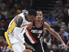 Los Angeles Lakers guard Kentavious Caldwell-Pope steals the ball from Portland Trail Blazers guard CJ McCollum during the first quarter of an NBA basketball game in Portland, Ore., Thursday, Nov. 2, 2017. (AP Photo/Steve Dykes)