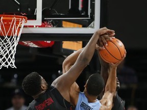 North Carolina's Garrison Brooks (15) gets his shot blocked by Arkansas' Trey Thompson (1) in the first half of an NCAA college basketball game during the Phil Knight Invitational tournament in Portland, Ore., Friday, Nov. 24, 2017. (AP Photo/Timothy J. Gonzalez)