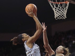 Connecticut's Azura Stevens, center, shoots over Michigan State's Jenna Allen, right, in the second half of an NCAA college basketball game during the Phil Knight Invitational tournament in Eugene, Ore., Saturday, Nov. 25, 2017. (AP Photo/Timothy J. Gonzalez)
