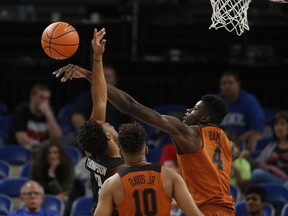 Butler's Aaron Thompson, left, has his shot blocked by Texas' Mohamed Bamba (4) in the first half of an NCAA college basketball game during the Phil Knight Invitational tournament in Portland, Ore., Thursday, Nov. 23, 2017. (AP Photo/Timothy J. Gonzalez)