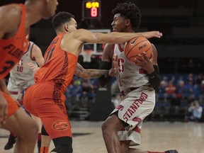 Florida's Chris Chiozza (11) steals the ball from Stanford's Daejon Davis (1) in the first half of an NCAA college basketball game during the Phil Knight Invitational tournament in Portland, Ore., Thursday, Nov. 23, 2017. (AP Photo/Timothy J. Gonzalez)