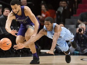 North Carolina guard Kenny Williams, right, dives for a loose ball against Portland guard D'Marques Tyson, left, during the first half in an NCAA college basketball game at the Phil Knight Invitation Tournament, in Portland, Ore., Thursday, Nov. 23, 2017. (AP Photo/Troy Wayrynen)