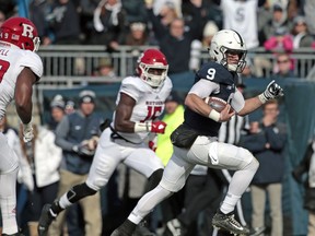 Penn State quarterback Trace McSorley (9) runs in for a touchdown against Rutgers during the first half of an NCAA college football game in State College, Pa., Saturday, Nov. 11, 2017. (AP Photo/Chris Knight)