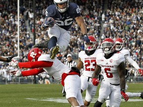 Penn State's Saquon Barkley (26) hurdles Rutgers' Kiy Hester (2) during the second half of an NCAA college football game in State College, Pa., Saturday, Nov. 11, 2017. Penn State 35-6. (AP Photo/Chris Knight)