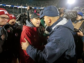 Penn State head coach James Franklin, right, shakes hands with Nebraska head coach Mike Riley, left, at the end of an NCAA college football game in State College, Pa., Saturday, Nov.18, 2017. Penn State won 56-44. (AP Photo/Chris Knight)