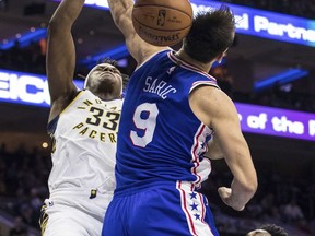 Indiana Pacers' Myles Turner, left, dunks the ball over Philadelphia 76ers' Dario Saric, of Croatia, during the first half of an NBA basketball game, Friday, Nov. 3, 2017, in Philadelphia. (AP Photo/Chris Szagola)