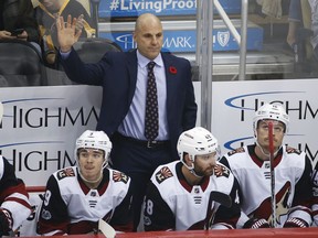 Arizona Coyotes coach Rick Tocchet acknowledges fans after a video tribute honoring his days as a player and coach for the Pittsburgh Penguins during a timeout in the first period of an NHL hockey game between the Coyotes and the Penguins, in Pittsburgh, Tuesday, Nov. 7, 2017. (AP Photo/Gene J. Puskar)