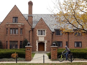 A bicyclist rides past Pennsylvania State University's shuttered Beta Theta Pi fraternity house Thursday, Nov. 9, 2017, in State College, Pa. Centre County, Pa., District Attorney Stacy Parks Miller announced Monday, Nov. 13, 2017, that more charges have been filed against fraternity brothers after investigators recovered deleted surveillance video footage recorded before the Feb. 4, 2017, death of 19-year-old Tim Piazza, of Lebanon, N.J., after a night of heavy drinking. (AP Photo/Gene J. Puskar)