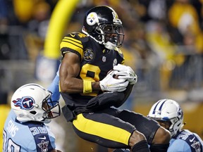 Pittsburgh Steelers wide receiver Antonio Brown (84) catches a pass from quarterback Ben Roethlisberger for a touchdown with Tennessee Titans cornerback LeShaun Sims (36) defending during the first half of an NFL football game in Pittsburgh, Thursday, Nov. 16, 2017. (AP Photo/Keith Srakocic)