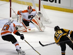 Pittsburgh Penguins' Jake Guentzel (59) shoots and scores past Philadelphia Flyers goalie Brian Elliott (37) with Brandon Manning (23) defending in the first period of an NHL hockey game in Pittsburgh, Monday, Nov. 27, 2017. (AP Photo/Gene J. Puskar)