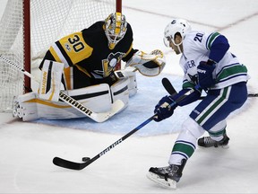 Vancouver Canucks' Brandon Sutter (20) can't get off a shot in front of Pittsburgh Penguins goalie Matt Murray (30) during the first period of an NHL hockey game in Pittsburgh, Wednesday, Nov. 22, 2017. (AP Photo/Gene J. Puskar)