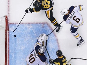 Pittsburgh Penguins' Sidney Crosby (87) puts a rebound behind Buffalo Sabres goalie Robin Lehner (40) for a goal in the second period of an NHL hockey game in Pittsburgh, Tuesday, Nov. 14, 2017. The Penguins won 5-4 in overtime. (AP Photo/Gene J. Puskar)