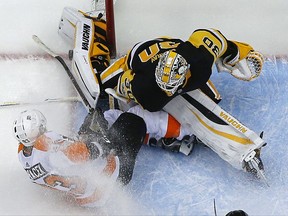 Philadelphia Flyers' Jakub Voracek (93) collides with Pittsburgh Penguins goalie Matt Murray (30) on a break away in the second period of an NHL hockey game in Pittsburgh, Monday, Nov. 27, 2017. Murray was injured on the play and left the game. The Penguins won 5-4. (AP Photo/Gene J. Puskar)