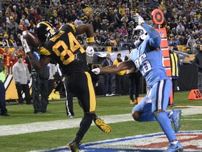Pittsburgh Steelers wide receiver Antonio Brown (84) comes down with a touchdown reception as Tennessee Titans cornerback Logan Ryan (26) defends during the second half of an NFL football game in Pittsburgh, Thursday, Nov. 16, 2017. (AP Photo/Don Wright)
