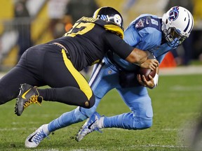 Tennessee Titans quarterback Marcus Mariota (8) is sacked by Pittsburgh Steelers defensive end Cameron Heyward (97) during the second half of an NFL football game in Pittsburgh, Thursday, Nov. 16, 2017. The Steelers won 40-17. (AP Photo/Keith Srakocic)