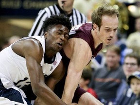Pittsburgh's Khameron Davis, left and Montana's Bobby Moorehead chase after a loose ball in the first half of an NCAA college basketball game, Monday, Nov. 13, 2017, in Pittsburgh. (AP Photo/Keith Srakocic)