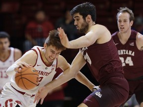 Stanford guard Robert Cartwright, left, is defended by Montana forward Fabijan Krslovic during the first half of an NCAA college basketball game Wednesday, Nov. 29, 2017, in Stanford, Calif. (AP Photo/Marcio Jose Sanchez)