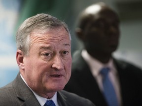 Philadelphia Mayor Jim Kenney, left, accompanied by City Solicitor Sozi Pedro Tulante, speaks during a news conference in Philadelphia, Wednesday, Nov. 15, 2017. A federal judge on Wednesday blocked the U.S. government from withholding a major grant that pays for public safety equipment because Philadelphia is a "sanctuary city." (AP Photo/Matt Rourke)