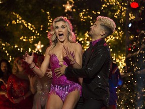 In this photo provided by ABC, Jordan Fisher, right, and Lindsay Arnold react after being named the champions of "Dancing with the Stars" on Nov. 21, 2017, in Los Angeles. Fisher beat out violinist Lindsey Stirling and actor Frankie Muniz for the Mirrorball Trophy on the season 25 finale of the ABC reality competition. (Eric McCandless/ABC via AP)