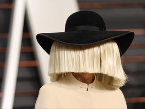 FILE - In this Feb. 22, 2015, file photo, Sia arrives at the 2015 Vanity Fair Oscar Party in Beverly Hills, Calif. Sia tweeted a nude photo of herself on Nov. 6, 2017, after learning that someone was trying to sell nude paparazzi photos of her. (Photo by Evan Agostini/Invision/AP, File)