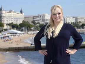FILE - In this Oct. 8, 2013, file photo, conservative commentator Meghan McCain poses during a photocall at the 29th MIPCOM (International Film and Programme Market for TV, Video, Cable and Satellite) in Cannes, France. McCain's father, U.S. Sen. John McCain, announced on Nov. 22, 2017, that his daughter married fellow conservative commentator Ben Domenech at the family's ranch in Arizona the day before. (AP Photo/Lionel Cironneau, File)