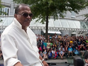FILE - In this Aug. 31, 2013, file photo, actor Billy Dee Williams, famous for his role as Lando Calrissian in the "Star Wars" movie series, rides atop a car in a parade during the annual Dragon Con sci-fi and fantasy convention in Atlanta. The American Black Film Festival Honors announced on Nov. 29, 2017, Williams will receive its Hollywood Legacy Award at its ceremony in February 2018. (AP Photo/ Ron Harris, File)