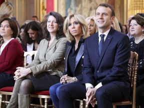 French President Emmanuel Macron, right, and his wife Brigitte Macron, second right, French Minister for Solidarity and Health Agnes Buzyn, second left, and French senator Laurence Rossignol listen as the French Junior Minister for Gender Equality addresses guests at the International Day for the Elimination of Violence Against Women, Saturday Nov. 25, 2017 at the Elysee Palace in Paris. (Ludovic Marin, Pool via AP)
