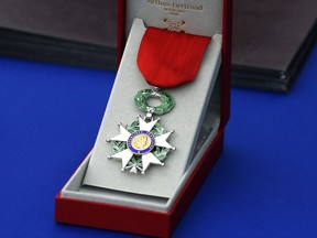FILE - In this Sept. 19, 2017 file photo, the National Order of the Legion of Honor (Légion d'Honneur) medal is seen during a ceremony at Los Angeles National Cemetery. The French government announced its decision Thursday Nov.2, 2017 to tighten rules to award the Legion of honor, France's highest distinction. Government spokesman said the number of awardees next year will decrease by 50 percent for civilians, 10 percent for soldiers and 25 percent for foreigners. (AP Photo/Reed Saxon, File)