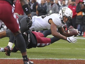 Central Florida's Gabriel Davis reaches for the goal line and scores a touchdown after being hit by Temple's Linwood Crump during the second quarter of an NCAA college football game Saturday, Nov. 18, 2017, in Philadelphia. (AP Photo/Rich Schultz)