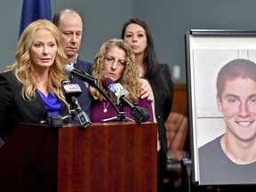 FILE – In this May 5, 2017, file photo, Centre County, Pa., District Attorney Stacy Parks Miller, left, announces findings an investigation into the death of Penn State University fraternity pledge Tim Piazza, seen in photo at right, as his parents, Jim and Evelyn Piazza, second and third from left, stand nearby during a news conference in Bellefonte, Pa. Parks Miller announced Monday, Nov. 13, 2017, that more charges have been filed against fraternity brothers after investigators recovered deleted surveillance video footage recorded before the Feb. 4, 2017, death of Piazza, of Lebanon, N.J., after a night of heavy drinking. (Abby Drey/Centre Daily Times via AP, File)/Centre Daily Times via AP)