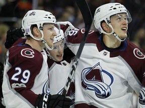 Colorado Avalanche's Nathan MacKinnon, left, Matt Duchene, center, and Mikko Rantanen, right, join to celebrate Duchene's goal during the first period of an NHL hockey game against the Philadelphia Flyers, Saturday, Nov. 4, 2017, in Philadelphia. (AP Photo/Tom Mihalek)