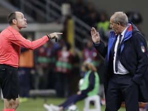 Referee Antonio Mateu Lahoz of Spain gestures when talking to Italy coach Gian Piero Ventura during the World Cup qualifying play-off second leg soccer match between Italy and Sweden, at the Milan San Siro stadium, Italy, Monday, Nov. 13, 2017. (AP Photo/Luca Bruno)