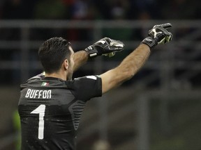 Italy goalkeeper Gianluigi Buffon gives directions to his teammates during the World Cup qualifying play-off second leg soccer match between Italy and Sweden, at the Milan San Siro stadium, Italy, Monday, Nov. 13, 2017. (AP Photo/Luca Bruno)