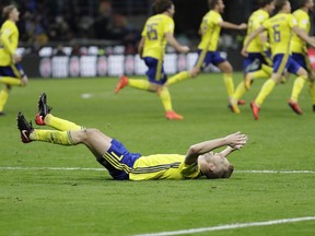 Swedish players react to their qualification at the end of the World Cup qualifying play-off second leg soccer match between Italy and Sweden, at the Milan San Siro stadium, Italy, Monday, Nov. 13, 2017. (AP Photo/Luca Bruno)