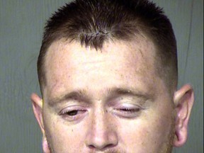 FILE - This undated file booking photo provided by the Maricopa County Sheriff shows Kansas Lavarnia. The murder charge against the Phoenix man in the shooting death earlier this year of his 9-year-old son has been dismissed at the request of prosecutors. (Maricopa County Sheriff via AP, File)