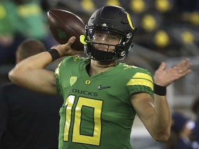 FILE - In this Sept. 30, 2017, file photo, Oregon quarterback Justin Herbert warms up before an NCAA college football game against California in Eugene, Ore. Herbert, who fractured his collarbone against California on Sept. 30, has been practicing lately and some say he appears ready to come back in their game against Arizona, Saturday, Nov. 18, 2017, in Eugene. (AP Photo/Chris Pietsch, File)