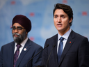 Prime Minister Justin Trudeau speaks at the 2017 UN peacekeeping conference in Vancouver on Wednesday, as Defence Minister Harjit Sajjan listens.