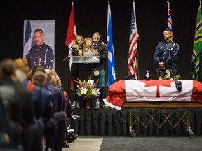 The family of Const. John Davidson speak during the funeral for their father in Abbotsford on Sunday.