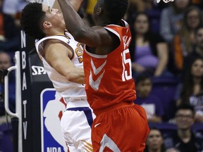 Houston Rockets center Clint Capela (15) arrives to block the shot of Phoenix Suns guard Devin Booker, left, during the first half of an NBA basketball game Thursday, Nov. 16, 2017, in Phoenix. (AP Photo/Ross D. Franklin)